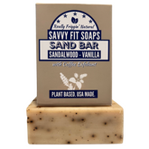 A box of Savvy Fit Soaps Sand Bar in Sandalwood Vanilla with an open soap, highlighting its plant-based, USA-made, and soothing skincare formula.